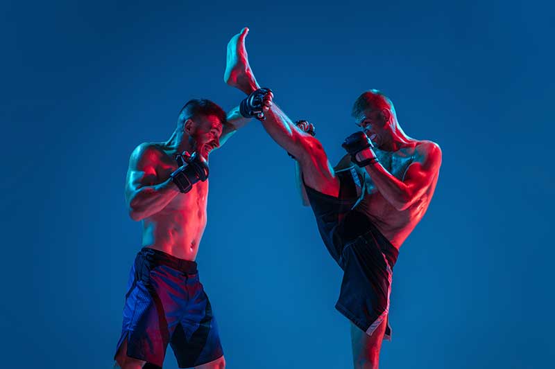 mma-two-professional-fighters-punching-boxing-isolated-blue-wall-neon.jpg